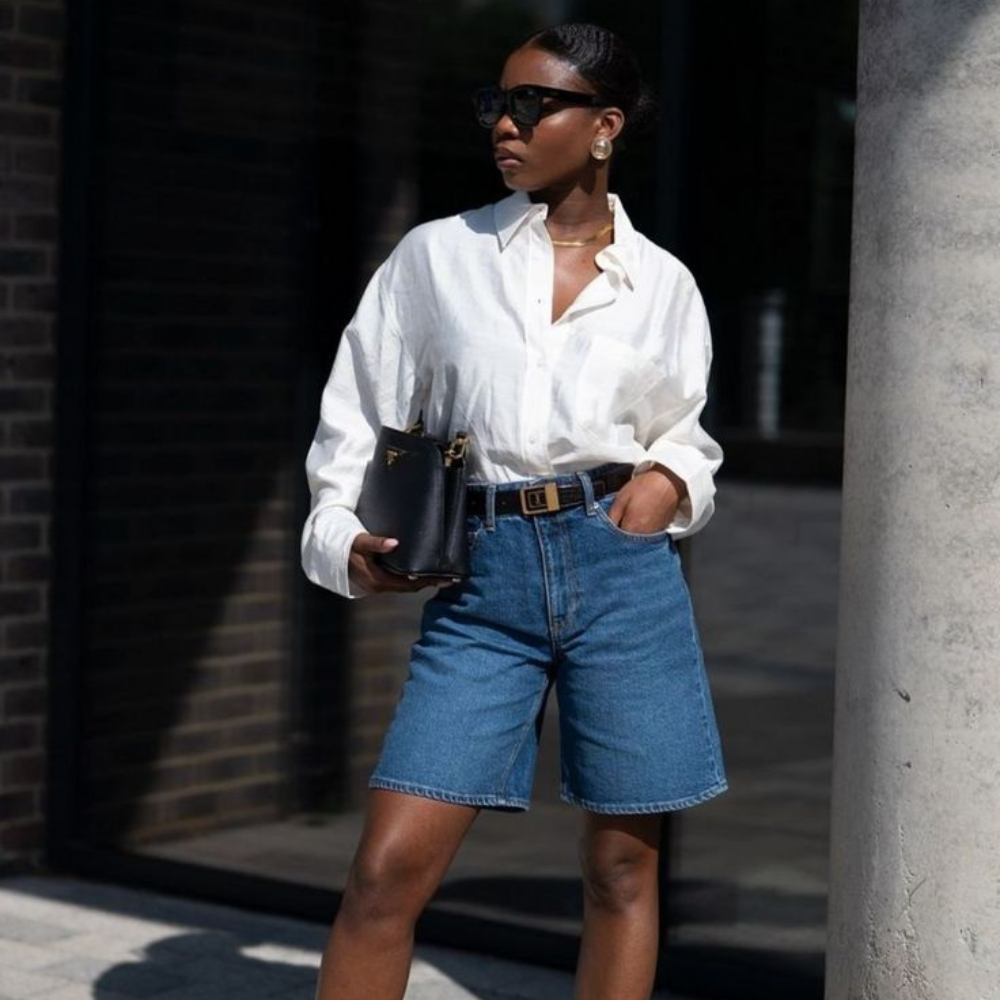 mature woman wearing denim jorts and white button down shirt
