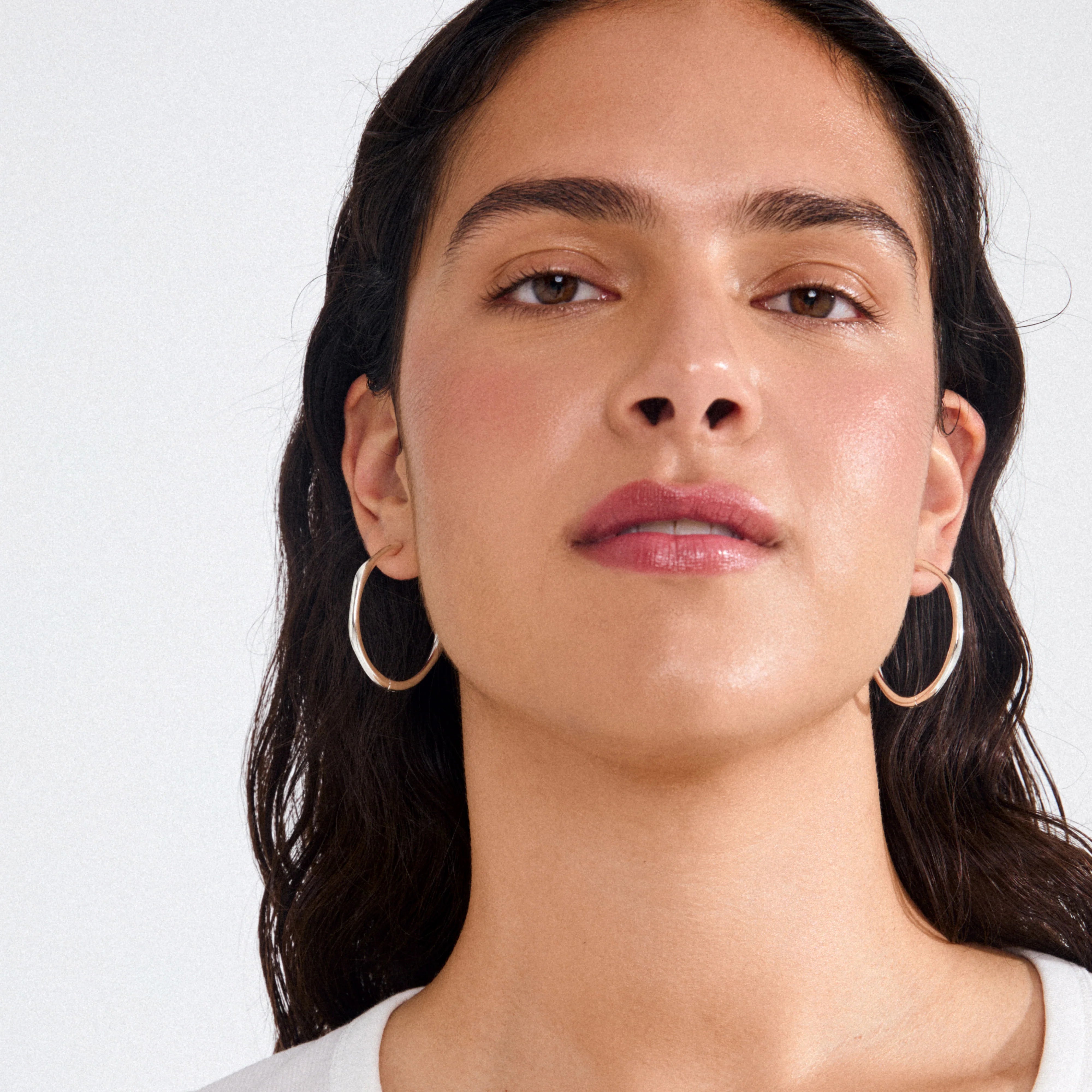 fashion jewelry, sculptural hoop earrings, lightweight silver hoops, silver statement earrings, chic silver jewelry, elevated everyday accessories