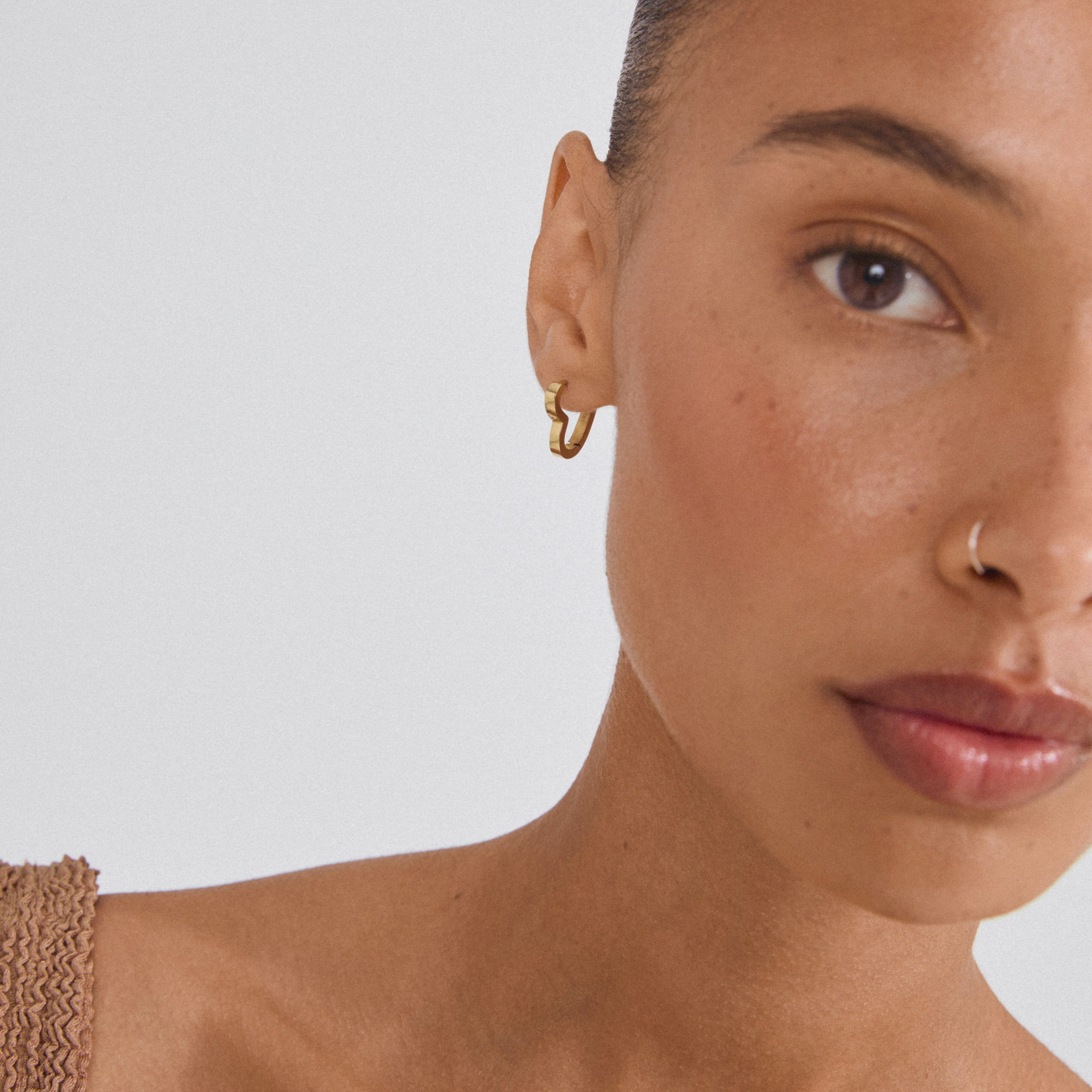gold heart hoop earrings, gold plated hoop earrings, heart shaped earrings, trendy gold earrings, womens gold jewelry, statement hoop earrings, minimalist gold hoops, gold plated jewelry, modern heart earrings, everyday gold earrings, stylish gold hoops, fashion earrings for women