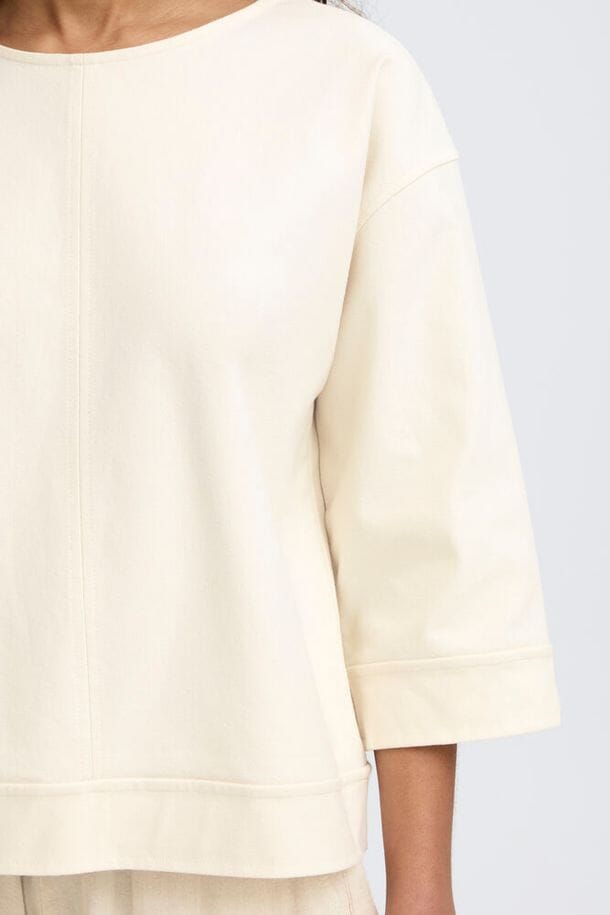 neutral denim blouse women, light denim shirt women outfit, relaxed denim top women, cream denim shirt women style, casual denim shirt women outfit