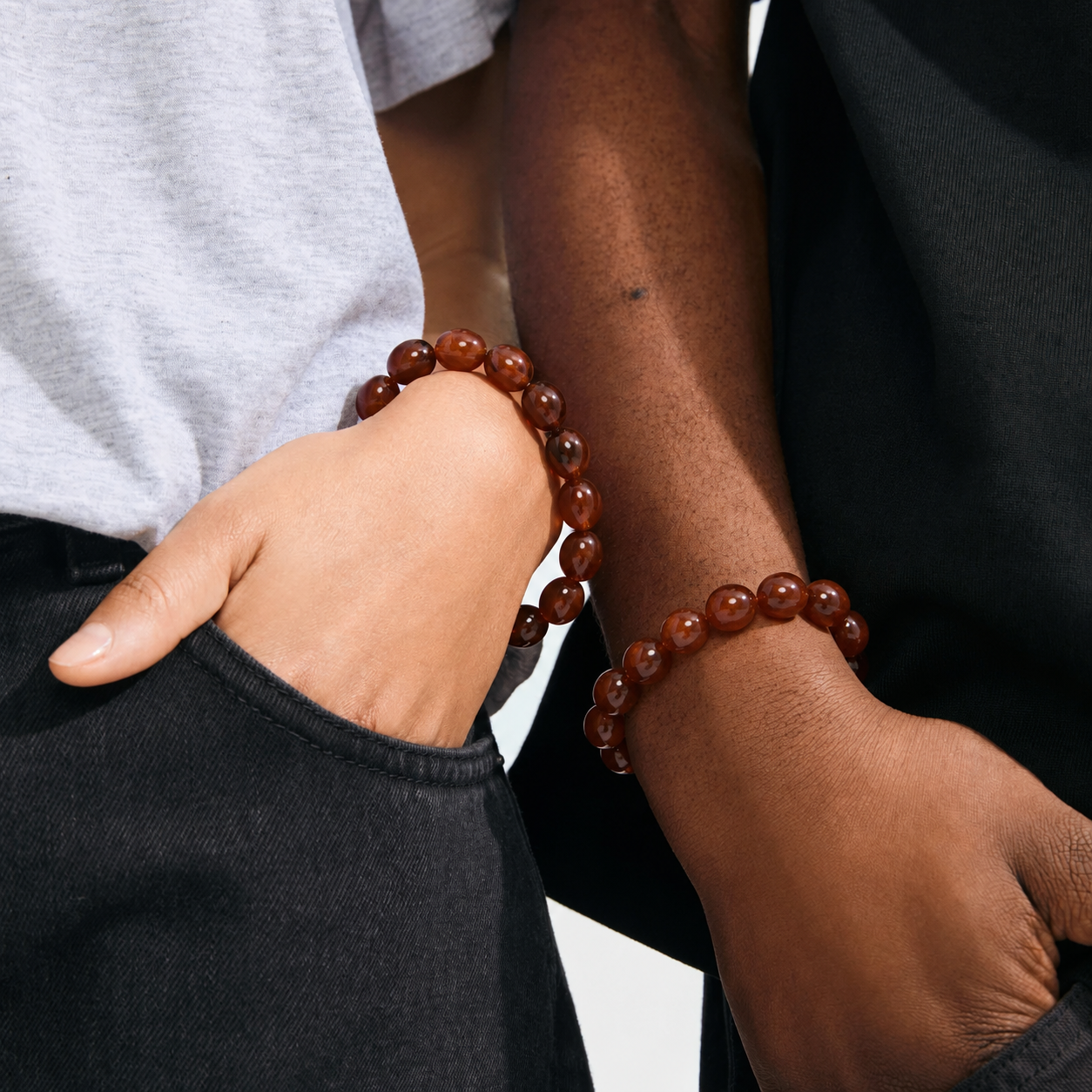 2 arms with beaded brown bracelets
