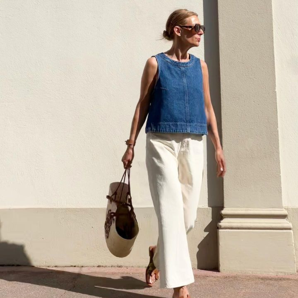 woman wearing cream jean pants and boxy denim tank.