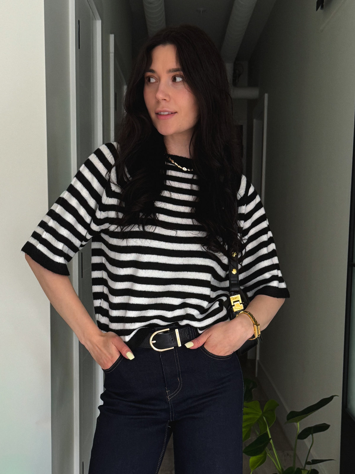 woman in stripped top with hands in pocket