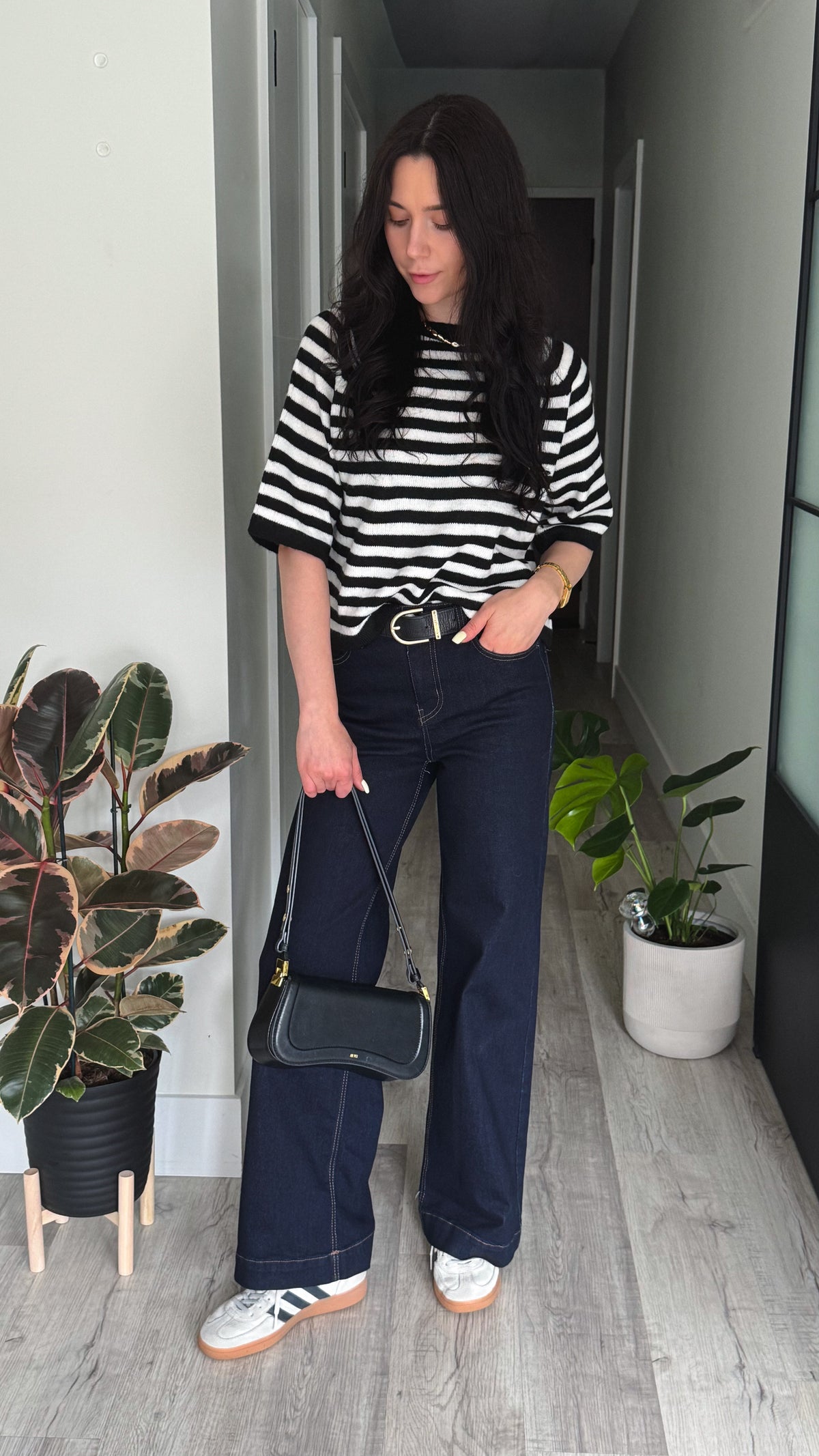 woman in stripped top with hands in pocket