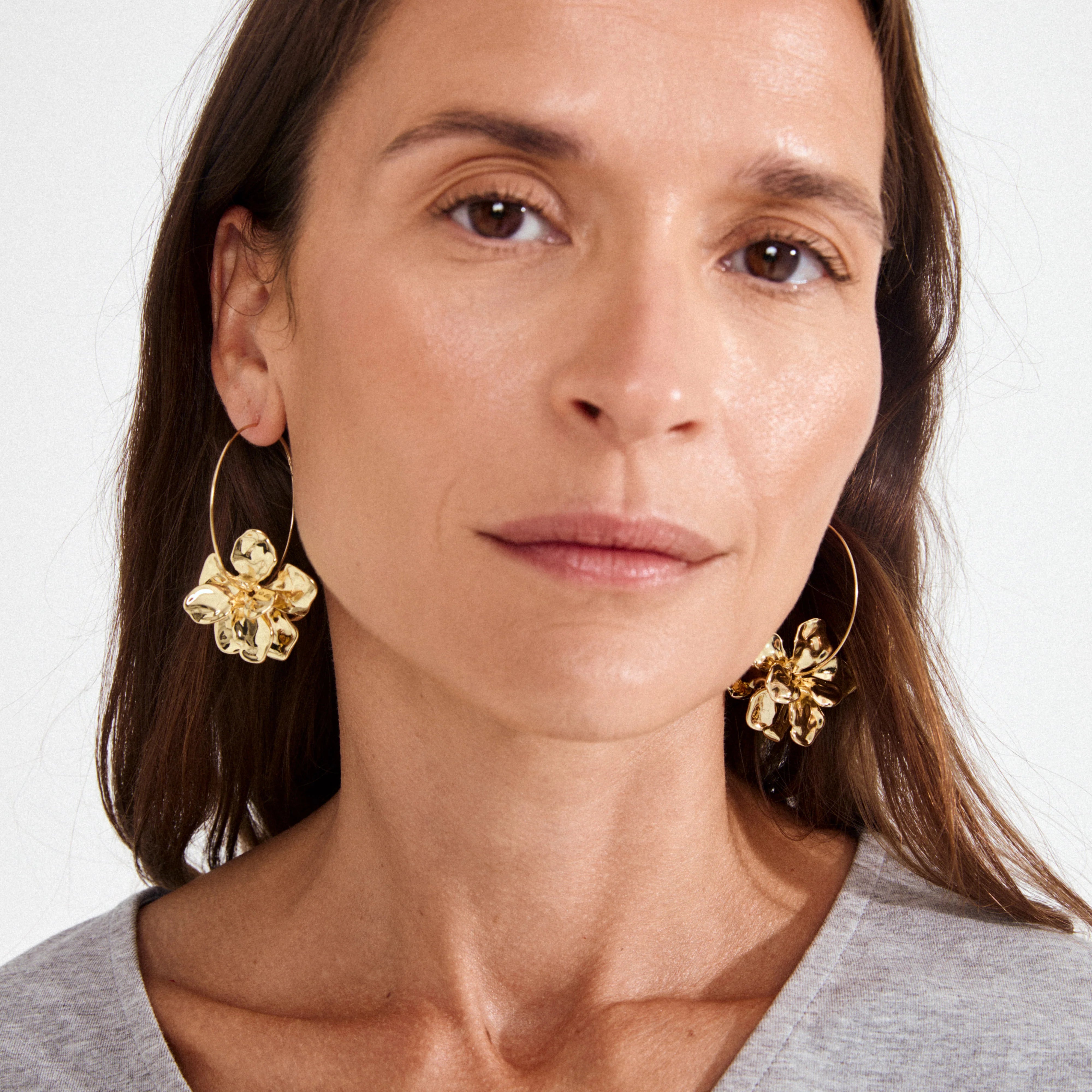 womens gold plated jewelry, trendy gold earrings for women, flower hoop earrings, statement flower earrings, vacation jewelry for women, polished gold earrings, modern floral jewelry, gold fashion earrings, elevated summer accessories,