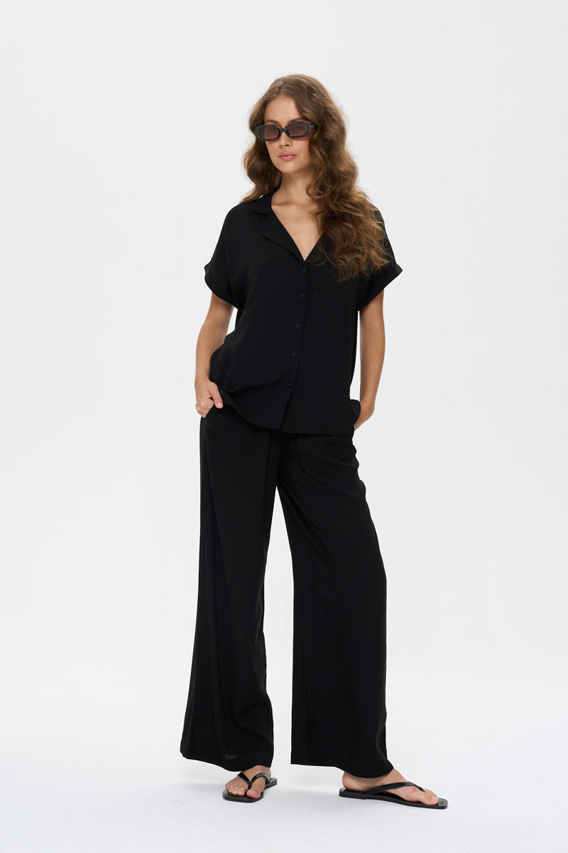 minimalist wardrobe staple, effortless black outfit, elevated basics women, black short sleeve blouse