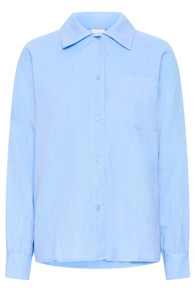 long sleeve button down women, minimal shirt women, blue shirt outfit styling, womens work shirt blue, versatile button up shirt, soft cotton blouse blue, classic wardrobe staple shirt, modern button down shirt, casual chic shirt women, breathable cotton shirt women