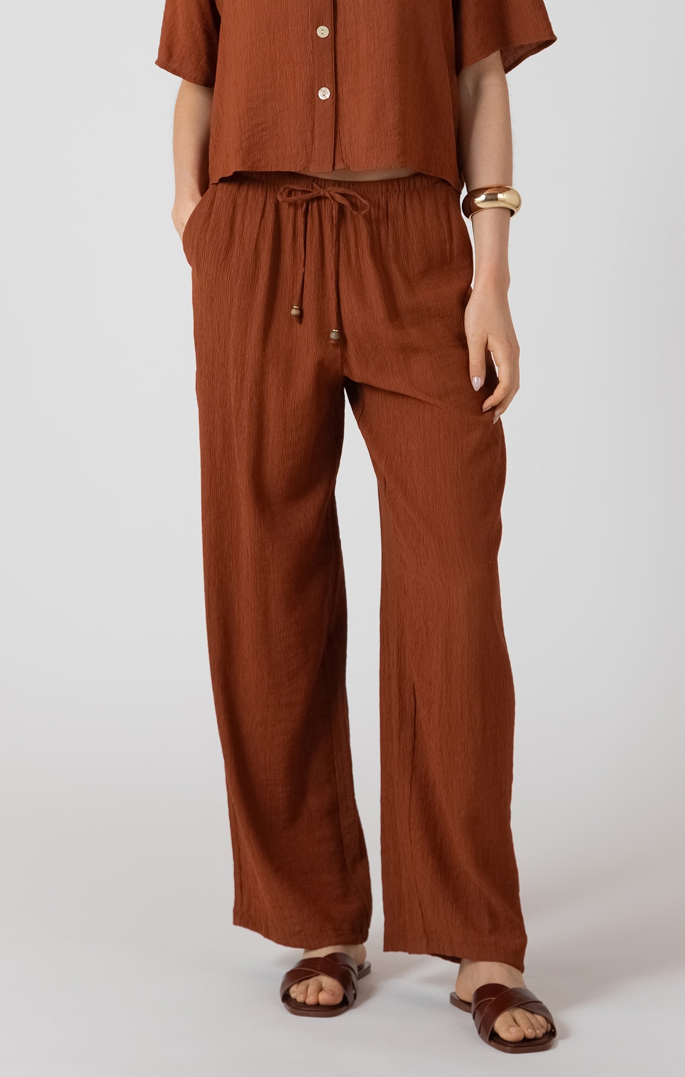 burnt sienna wide leg pants, burnt sienna trousers women, rust wide leg pants outfit, terracotta wide leg trousers, relaxed drawstring waist pants women, earthy tone summer trousers, wide leg casual pants women, rust linen look pants women, relaxed fit trousers women outfit, neutral earth tone clothing women