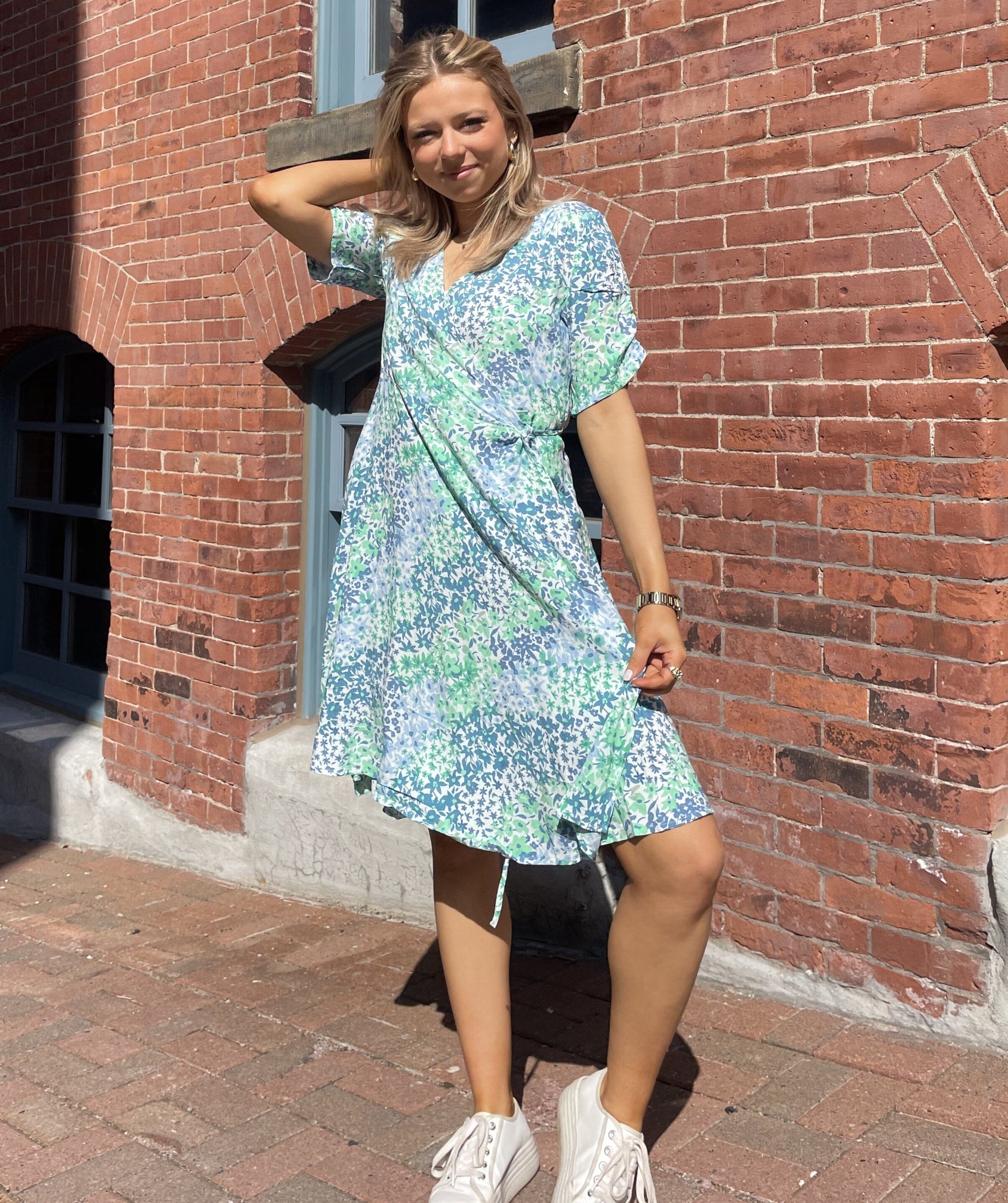 Our Printed Wrap Dress is a must-have addition to your wardrobe. The wrap design and above knee length create a flattering silhouette that accentuates your curves in all the right places. The dress features a stylish print that exudes femininity and elegance. 