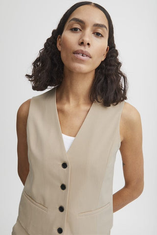 Beige fitted vest with a flattering cut.